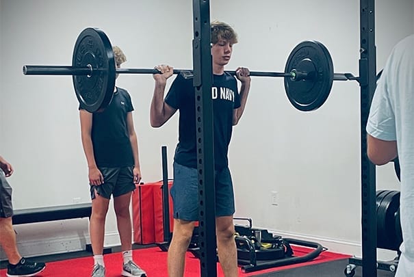 teen lifting weights at CoreFit Training Studio