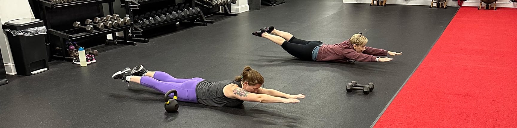 women doing planks and training at your own fitness goals at CoreFit Training Studio